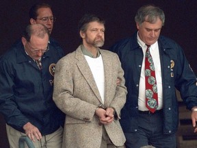 FILE - Theodore Kaczynski looks around as U.S. Marshals prepare to take him down the steps at the federal courthouse to a waiting vehicle on June 21, 1996, in Helena, Mont.