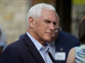 FILE - Former Vice President Mike Pence talks with local residents during a meet and greet on May 23, 2023, in Des Moines, Iowa. Pence will officially launch his widely expected campaign for the Republican nomination for president in Iowa on June 7.
