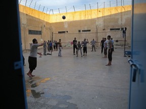 FILE - In this April 3, 2018 file photo, prisoners play volleyball, in a Kurdish-run prison housing former members of the Islamic State group, in Qamishli, north Syria. The Kurdish-led authority in northeast Syria announced Saturday, June 10, 2023 that hundreds of fighters with the Islamic State group held in prisons around the region will be put on trial after their home countries refused to repatriate them.