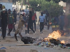 A demonstrator throws a rock at police during a protest at a neighborhood in Dakar, Senegal, Saturday, June 3, 2023. The clashes first broke out later this week after opposition leader Ousmane Sonko was convicted of corrupting youth and sentenced to two years in prison.