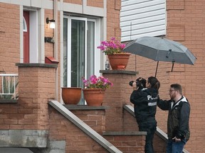 Montreal police investigators take pictures at the scene of double homicide at Terrasse J-S Aime Visby in Lachine July 27, 2023.