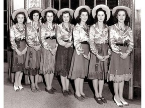 July 7, 1942: These Eatons elevator operators present very different Calgary Stampede fashions from what's seen today. They sport fringed style skirts, shiny satin blouses and Panama style straw hats. Perhaps the most changed item of clothing is the footwear. Boots have replaced the pumps and casual shoes seen here. Calgary Herald Archives.