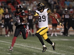 Ottawa Redblacks defensive back Douglas Coleman III chases Hamilton Tiger-Cats quarterback Kai Locksley as he runs for a touchdown during second half CFL action, Friday, July 28, 2023 in Ottawa.
