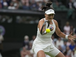Canada's Bianca Andreescu returns to Tunisia's Ons Jabeur in a women's singles match on day six of the Wimbledon tennis championships in London, Saturday, July 8, 2023.