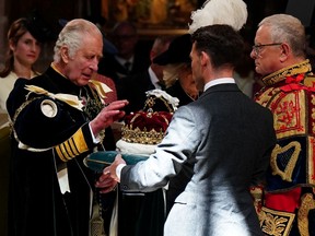 Britain's King Charles III is presented with the Crown of Scotland during a National Service of Thanksgiving and Dedication inside St Giles' Cathedral in Edinburgh on July 5, 2023. Scotland on Wednesday marked the Coronation of King Charles III and Queen Camilla during a National Service of Thanksgiving and Dedication where the The King was presented with the Honours of Scotland.