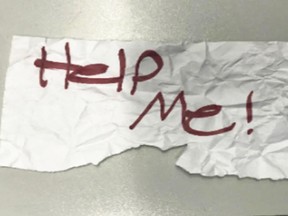 A "Help Me!" sign used by a 13-year-old girl kidnapped in Texas.