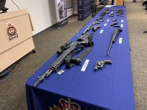 London police display some of the 26 guns seized during a four-month series of raids dubbed Project SAFE. Photo taken on Thursday July 27, 2023. Derek Ruttan/The London Free Press