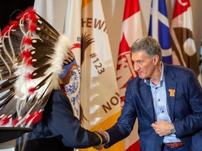 Greg Desjarlais, Chief of Frog Lake First Nation, shakes hands with Al Monaco, President and CEO, Enbridge