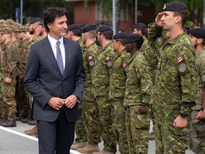 Prime Minister Justin Trudeau inspects Canadian troops in Latvia.