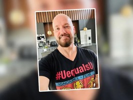 A man with a shaved head anf full beard smiles for the camera. Randy was diagnosed with HIV and had to deal with the stigma associated with the condition.