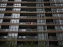 A Canadian flag on a condo balcony in Toronto. The city suffers from health-care shortages and unaffordable housing prices.
