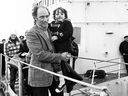 Prime Minister Pierre Trudeau carries son Justin from HMCS Restigouche in Powell River, B.C., before arriving in Vancouver for a UN conference in 1976.