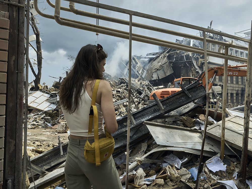 A woman watches as emergency service personnel work at the site of a destroyed building after a Russian attack in Odesa, Ukraine, July 20, 2023. Russia pounded Ukraine’s southern cities, including the port city of Odesa, with drones and missiles in a wave of strikes that has destroyed some of the country’s critical grain export infrastructure.
