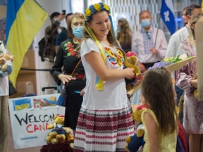 Ukrainian refugees are welcomed at Pierre Trudeau airport in Montreal.