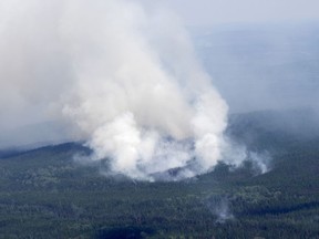Ottawa is sending Canadian Rangers and deploying air assets to help with evacuations due to wildfires in northern Quebec. A smoke plume is seen rising from the forest south of Lebel-sur-Quevillon, Que., Wednesday, July 5, 2023.