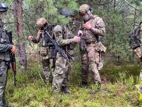 FILE - In this grab taken from video released by Belarus' Defense Ministry on Thursday, July 20, 2023, Belarusian soldiers of the Special Operations Forces (SOF) and mercenary fighters from Wagner private military company attend the weeklong maneuvers conducted at a firing range near the border city of Brest, Belarus. The Polish prime minister says that over 100 mercenaries belonging to the Russian-linked Wagner group in Belarus have moved close to the border with Poland. Mateusz Morawiecki said at a news conference Saturday, July 29, 2023 that the mercenaries had moved close to the Suwalki Gap, a strategic stretch of Polish territory situated between Belarus and Kaliningrad, a Russian territory separated from the mainland. (Belarus' Defense Ministry via AP, File)