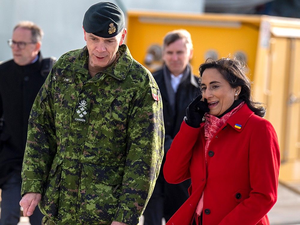 Defence Minister Anita Anand, right, walks with Gen. Wayne Eyre