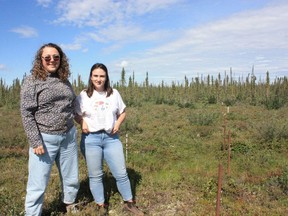Erica Hille, acting director at the Western Arctic Research Centre, left, and Jennifer Humphries, permafrost specialist at the Aurora Research Institute, at a monitoring site in Inuvik, N.W.T., July 5, 2023.