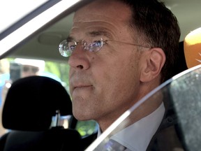 Dutch Prime Minister Mark Rutte sits in a car as he leaves Palace Huis ten Bosch in The Hague, Netherlands.