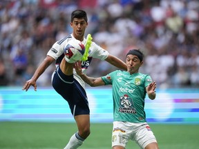 Vancouver Whitecaps' Mathias Laborda, left, knocks down a pass intended for Club Leon's Omar Fernandez with his foot during the first half of a Leagues Cup soccer match in Vancouver, on Friday, July 21, 2023.