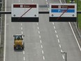 A forklift drives past terminal direction signs