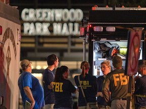 FILE - FBI agents gather at the scene of a deadly shooting, July 17, 2022, at the Greenwood Park Mall in Greenwood, Ind. The cellphone of a 20-year-old man who fatally shot three people at the Indianapolis-area mall in 2022 contained photos of Adolf Hitler, Nazi propaganda and firearms and also "extremely graphic" videos of previous mass killings, police said Thursday, July 13, 2023.