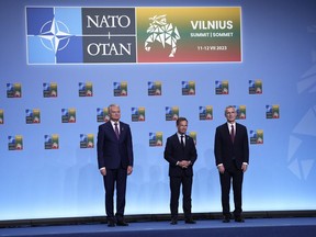 NATO Secretary General Jens Stoltenberg, right, Sweden's Prime Minister Ulf Kristersson, center, and Lithuania's President Gitanas Nauseda, left, pose during arrivals for the family photo at the NATO summit in Vilnius, Lithuania, Tuesday, July 11, 2023.