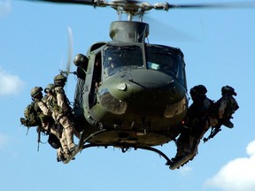 A file photo shows troops from the Canadian Special Operations Regiment (CSOR) preparing to rappel from a CH-146 Griffon helicopter from 427 Special Operations Aviation Squadron during a training exercise.