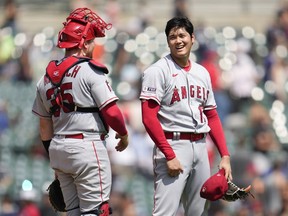 Los Angeles Angels pitcher Shohei Ohtani celebrates with catcher Chad Wallach (35) after the final out in the ninth inning during the first baseball game of a doubleheader, Thursday, July 27, 2023, in Detroit.
