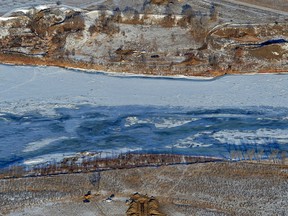 FILE - Photo crews work to contain an oil spill from Bridger Pipeline's broken pipeline near Glendive, Mont., on Jan. 19, 2015, in this aerial view showing both sides of the river. The U.S. Environmental Protection Agency on Monday, July 31, 2023, announced the settlement in a 2022 federal court lawsuit. Belle Fourche Pipeline Company and Bridger Pipeline LLC will pay the $12.5 million to resolve the claims made under the Clean Water Act and Pipeline Safety Laws, EPA said.