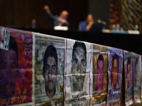 Photographs of missing students are displayed during a press conference by the Interdisciplinary Group of Independent Experts (GIEI) in Mexico City, Tuesday, July 25, 2023. The GIEI presented its sixth and last report on the case of the 43 students from Ayotzinapa who disappeared on Sept. 26, 2014.