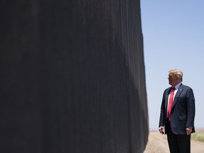 FILE - In this June 23, 2020, file photo, President Donald Trump tours a section of the border wall in San Luis, Ariz. Wisconsin is dropping out of two multistate lawsuits that challenged Trump's decision to divert billions of dollars to fund a wall across the southern U.S. border. Lawmakers in Wisconsin granted the state Justice Department permission to exit the lawsuits on Tuesday, July 25, 2023.
