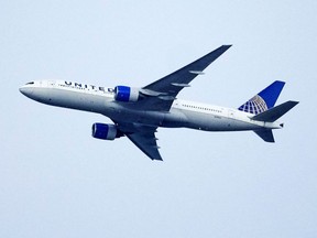 FILE - A United Airlines jetliner soars past an MLS soccer match July 8, 2023, in Commerce City, Colo. United Airlines and the union representing its pilots said Saturday, July 15, 2023, they reached agreement on a contract that will raise pilot pay by up to 40% over four years.
