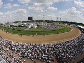 FILE - Fans watch a race before the 141st running of the Kentucky Derby horse race at Churchill Downs in Louisville, Ky., May 2, 2015. Racing will resume at Churchill Downs in September 2023 with no changes being made after a review of surfaces and safety protocols in the wake of 12 horse deaths, including seven in the days leading up to the Kentucky Derby in May.