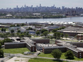FILE - The Rikers Island jail complex stands with the Manhattan skyline in the background, June 20, 2014, in New York. A federal prosecutor said Monday, July 17, 2023, his office is seeking to have control of New York City's trouble-plagued jail taken away from Mayor Eric Adam's administration, calling conditions there a "collective failure with deep roots."
