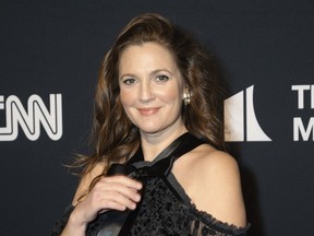 FILE - Drew Barrymore appears at the 24th Annual Mark Twain Prize for American Humor at the Kennedy Center for the Performing Arts on March 19, 2023, in Washington. Barrymore will host the National Book Awards, where Oprah Winfrey will be a guest speaker.
