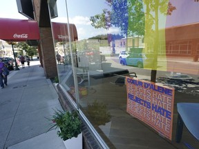 FILE - A sign that reads "Coeur d'Alene Rejects Hate" is shown under a pride flag in the window of the Emerge CDA art gallery, July 18, 2022, in downtown Coeur d'Alene, Idaho. A northern Idaho jury on Thursday, July 20, 2023, found five members of the white nationalist hate group Patriot Front guilty of misdemeanor charges of conspiracy to riot at a Pride event.
