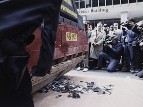 FILE - Cassettes and CDs by Irish singer Sinéad O'Connor are flattened by a pavement roller on New York City's Avenue of the Americas, Oct. 21, 1992. The recordings, donated by unhappy record fans, were collected by the National Ethnic Coalition of Organizations, which planned to deliver the crushed remains to the singer. In 1992, O'Connor destroyed a photo of Pope John Paul II on U.S. national television. The pushback was swift, turning the late Irish singer-songwriter's protest of sex abuse in the Catholic Church into a career-altering flashpoint.