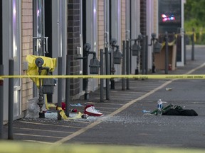 A running shoe, broken glass, and other evidence is seen in a parking lot following a quadruple shooting in Mississauga, Ont., on Saturday, July 1, 2023.