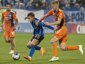 CF Montreal's Bryce Duke, centre, tries to keep the ball away from New York City FC's Keaton Parks during first half MLS action in Montreal, Saturday, July 1, 2023.