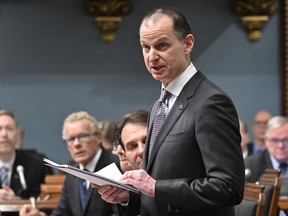 Quebec Finance Minister Eric Girard reads his budget speech, Tuesday, March 21, 2023, at the legislature in Quebec City. The Quebec government has introduced a regulation to ban people convicted of certain crimes from province-owned casinos.
