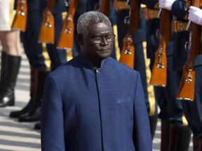 FILE - Solomon Islands Prime Minister Manasseh Sogavare reviews an honor guard during a welcome ceremony at the Great Hall of the People in Beijing, on Oct. 9, 2019. Solomon Islands Prime Minister Sogavare will visit China next week, highlighting the accelerating contest between Beijing and Washington for influence in the South Pacific.