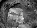 A miner hauling a car of silver radium ore, 340 feet below the surface at the Eldorado Mine of Great Bear Lake.
