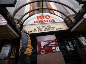 The owner of Vancouver's Rio Theatre is anxiously awaiting any new developments in a pair of Hollywood strikes that stand to slow down the flow of content to movie theatres. A person past the independent Rio Theatre, displaying a public health-related message on its marquee in Vancouver, B.C., Sunday, Dec. 6, 2020.