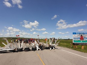 Activists for Indigenous rights blockade the main road into the Brady Road landfill, just outside of Winnipeg, Monday, July 10, 2023, after the city issued an order to vacate the blockade site by Monday at noon.