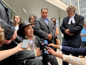 Newly acquitted Allan Woodhouse, front left to right, and Brian Anderson and James Lockyer, one of the lawyers for the two men and director of Innocence Canada, speak to the media outside the Winnipeg Law Courts in Winnipeg on Tuesday, July 18, 2023.