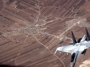 In this image from video released by the U.S. Air Force, a Russian SU-35 flies near a U.S. Air Force MQ-9 Reaper drone on Wednesday, July 5, 2023, over Syria.