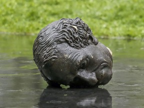 The head of the Sir John A. Macdonald statue lies separated from its body after it was pulled down during a demonstration by the Coalition for BIPOC Liberation in Montreal on Saturday, Aug. 29, 2020.