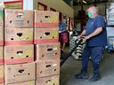  Workers load flats of food from donations and grocery stores into the Ottawa Food Bank's warehouse near St. Laurent Blvd.