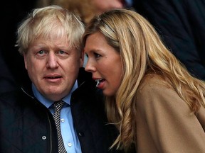 Britain's Prime Minister Boris Johnson with his partner Carrie Symonds at a rugby match on March 7, 2020.